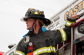 Fire fighter next to the fire truck.